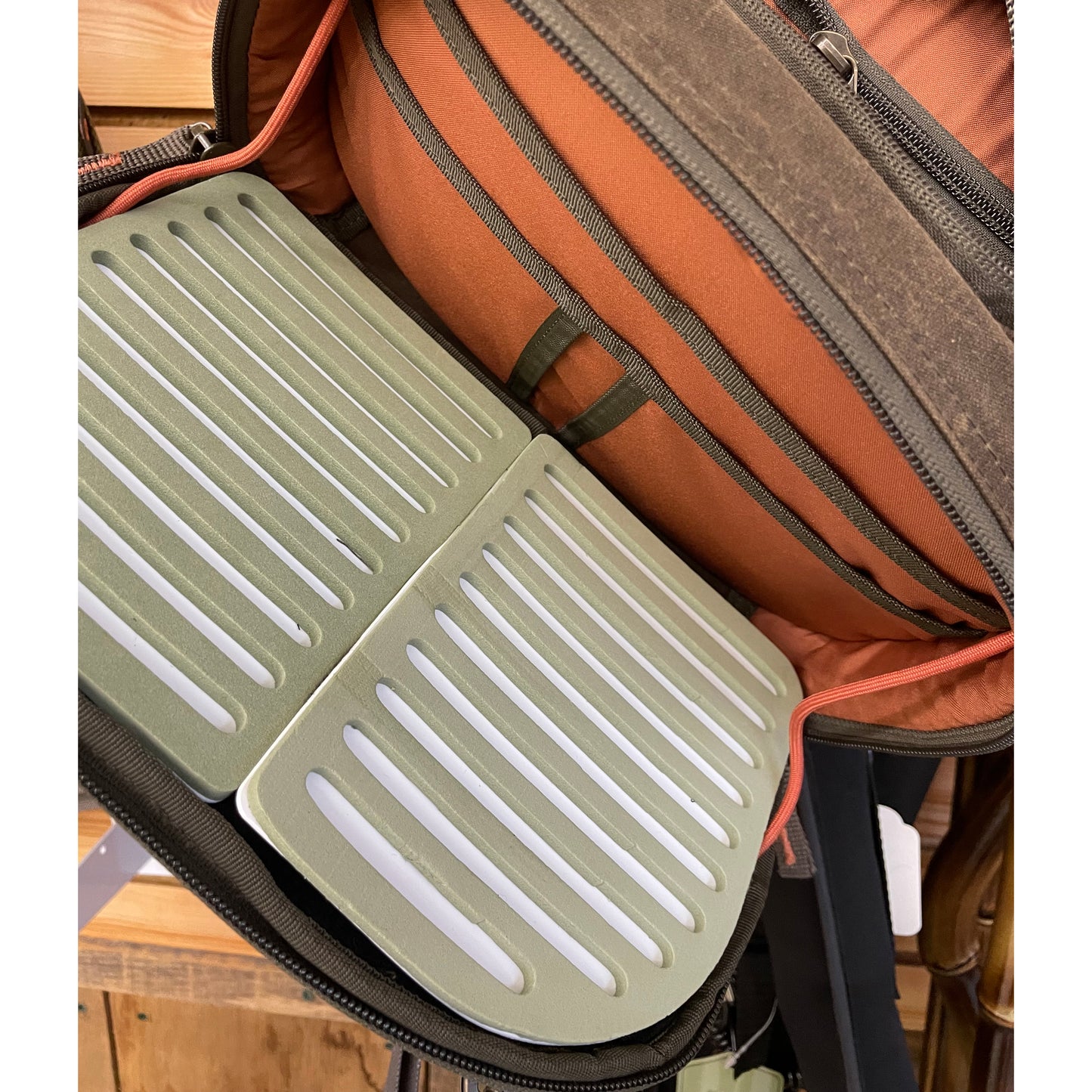 Fishpond Blue River Chest/Lumbar Fishing Pack shown with the Fly Bench storage area and 5 accessory pockets which are in the middle zippered compartment of this tackle pack